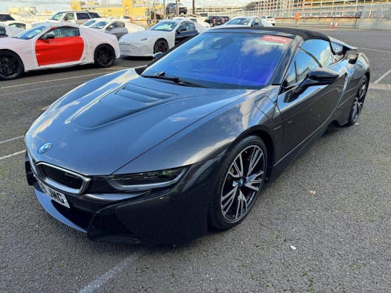 Dark grey BMW i8 Roadster in an export yard