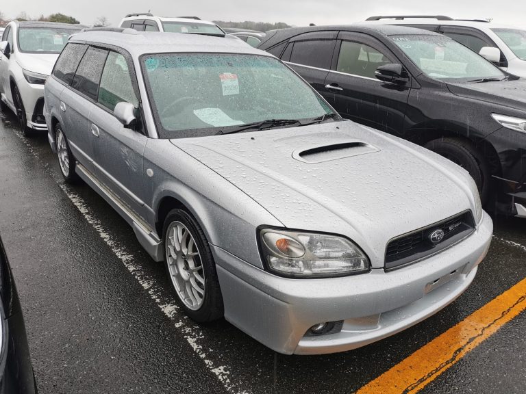 Silver Subaru Legacy wagon with an auction windshield sticker